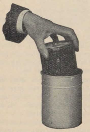 Hand lowering the transferring reel into the cylindrical solution cup.