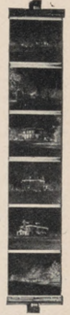 Vertical negative strip suspended between two film clips.