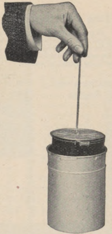 Wire hook lifting the transferring reel from the solution cup.